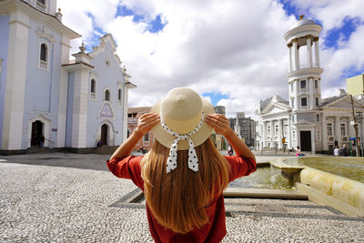 Back view of young tourist woman in the historic center of curitiba, parana, brazil.