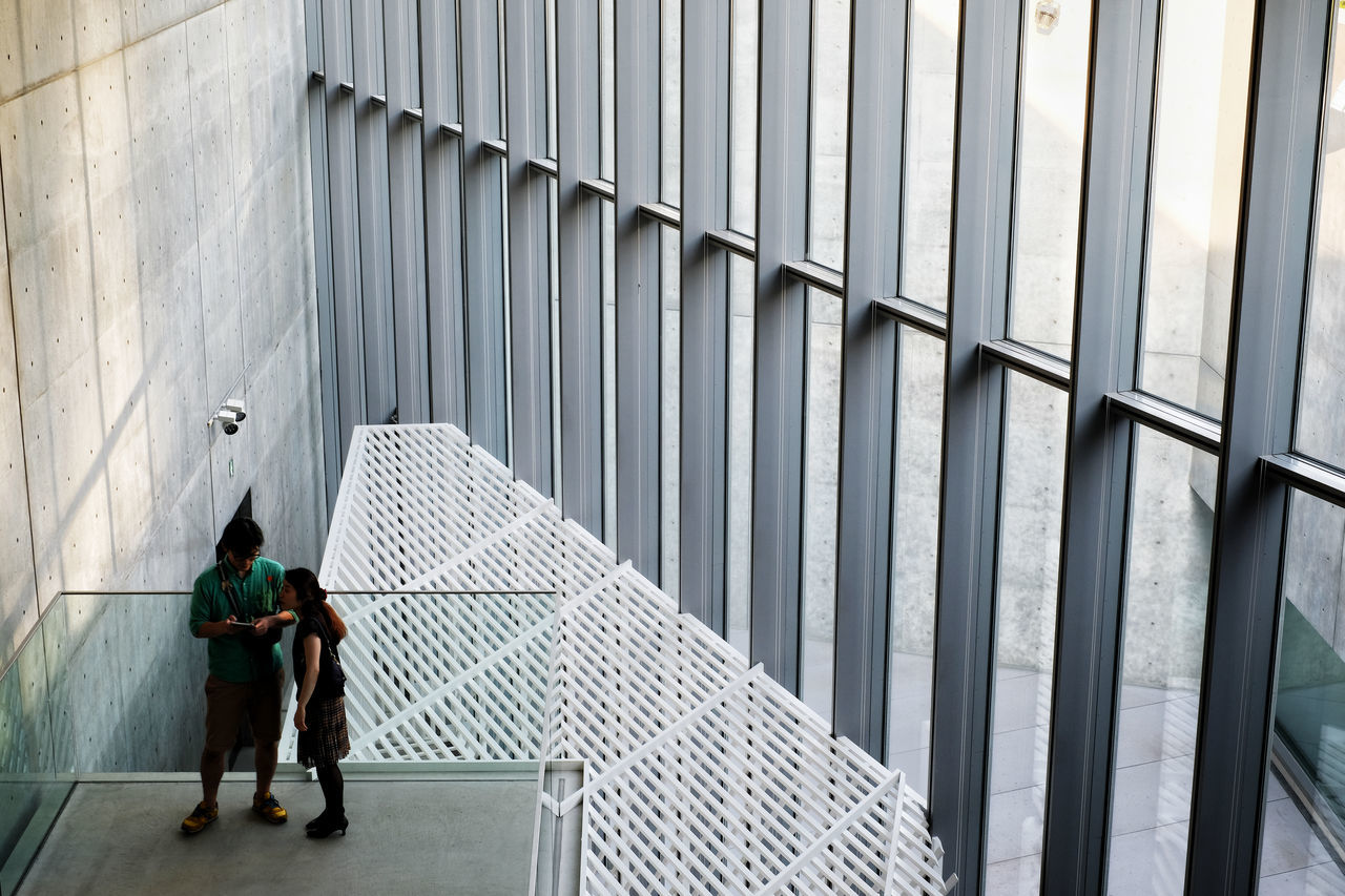 full length, architecture, adult, day, building exterior, built structure, people, women, walking, real people, men, two people, rear view, building, outdoors, metal, modern, lifestyles, the way forward