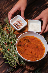 Midsection of person having food on table