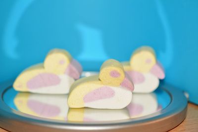 Close-up of bird shape marshmallows served on table