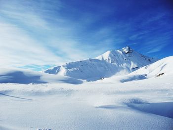 Scenic view of snow covered mountains against sky during winter