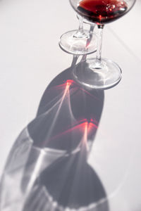 Close-up of wineglass on table against white background