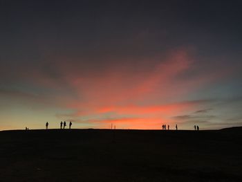 Silhouette landscape against sky during sunset