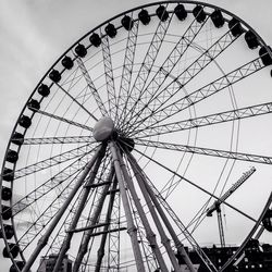 Low angle view of ferris wheel against sky