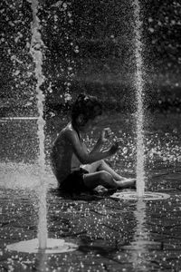 Woman splashing water in rain