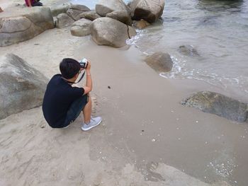 High angle view of person photographing on beach