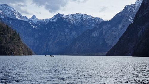 Scenic view of sea and mountains against sky