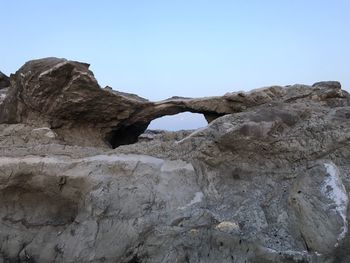 Low angle view of rock formation against clear sky