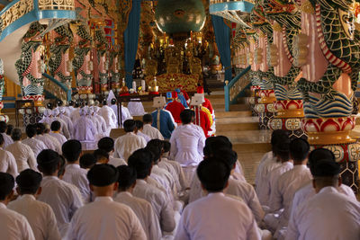 Group of people at temple cao dai