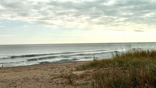 View of calm beach against the sky