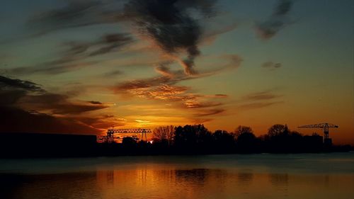 Scenic view of lake against orange sky