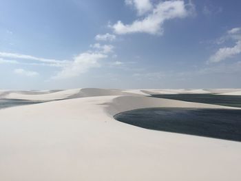 View of desert against cloudy sky