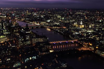 Aerial view of city lit up at night