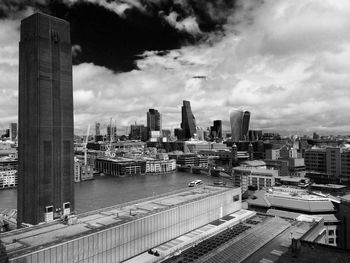 Cityscape against cloudy sky