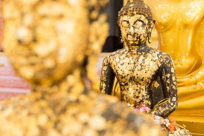 Close-up of statue against temple outside building