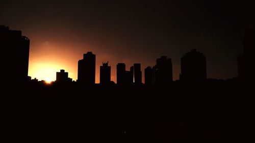 Silhouette of skyscrapers at sunset