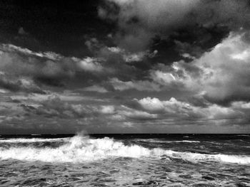 Scenic view of sea against cloudy sky