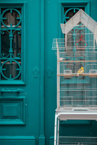 Birdcage against closed doors