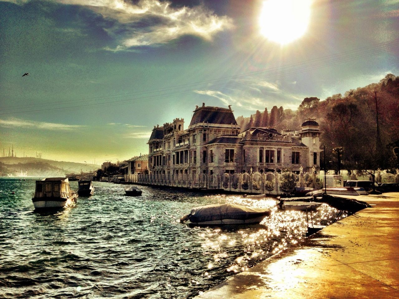 building exterior, architecture, built structure, water, nautical vessel, sky, waterfront, boat, transportation, sea, mode of transport, house, sunlight, cloud - sky, moored, residential structure, river, residential building, cloud, canal