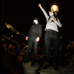 People standing on illuminated stage at night