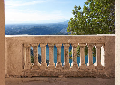 Built structure against trees and mountains against sky