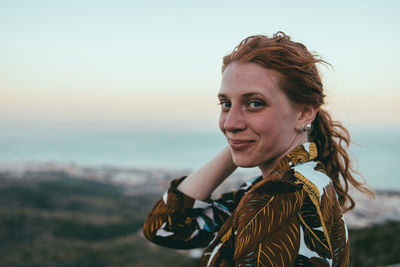 Portrait of smiling woman standing outdoors