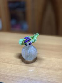 Close-up of purple flower vase on table