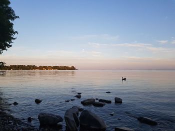 Scenic view of sea against sky at sunset