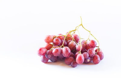 Close-up of grapes against white background