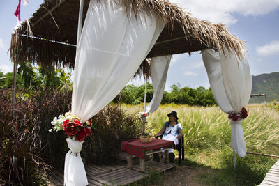 People sitting on chair in field