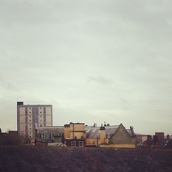 Buildings against cloudy sky