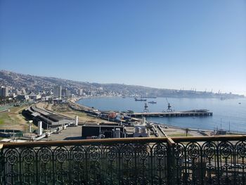 Bridge over sea against clear blue sky