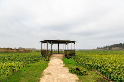 Gazebo on field against sky