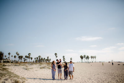 Family of five walking on beach