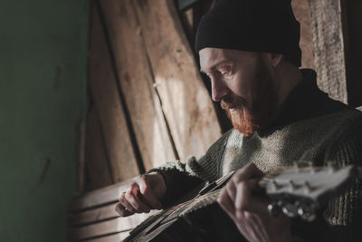 Midsection of man playing with hat