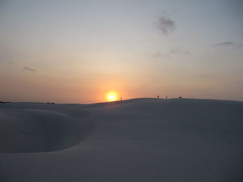 Scenic view of desert against sky during sunset