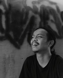 Portrait of smiling young man looking away