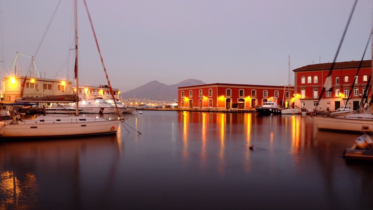 reflection, nautical vessel, water, transportation, mode of transport, waterfront, moored, built structure, architecture, building exterior, no people, clear sky, outdoors, sky, tranquility, nature, yacht, sea, travel destinations, harbor, sailboat, mast, day, illuminated, beauty in nature