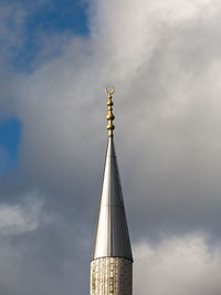 Low angle view of communications tower against sky