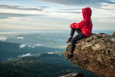 Man looking at view of mountain against sky