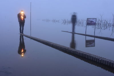 Reflection of illuminated street light in water