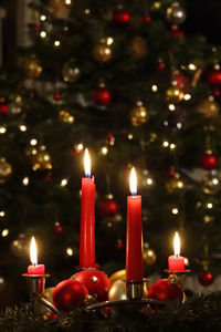 Close-up of illuminated candles against blurred background