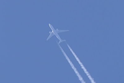 Low angle view of airplane flying in sky