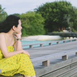 Woman sitting on pier