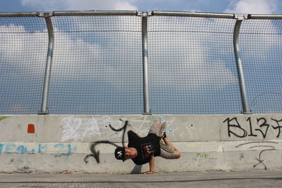 Man with graffiti on wall