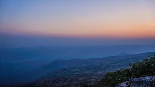 Scenic view of mountains against sky at sunset