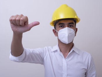 Portrait of man working against white background