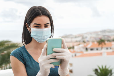 Portrait of young woman using smart phone