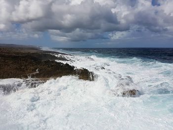 Scenic view of sea against storm clouds