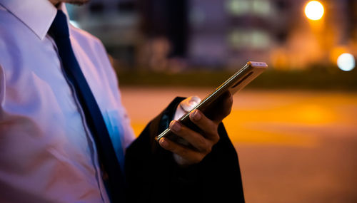 Midsection of woman using mobile phone